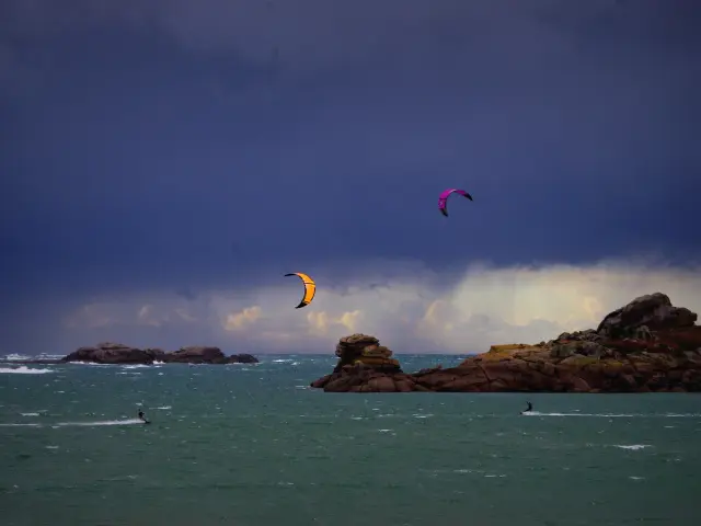 Un Kitesurf sous un ciel de tempête à Grève Rose à Trégastel