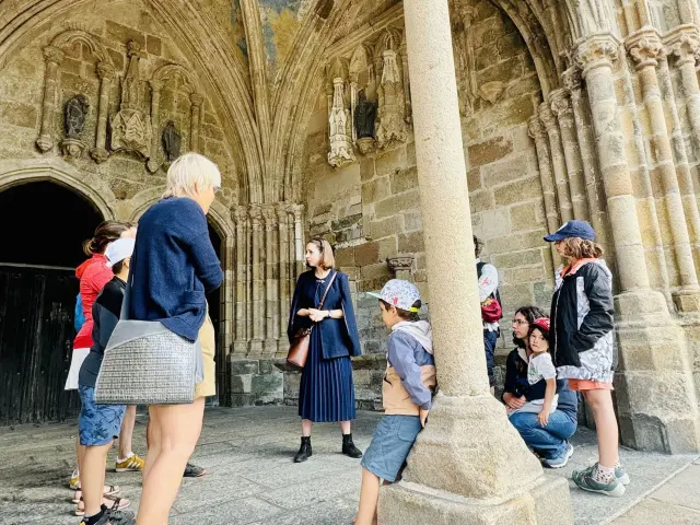 Balade ludique de Tréguier. La guide lance l'intrigue de la visite sous un porche de la cathédrale Saint-Tugdual