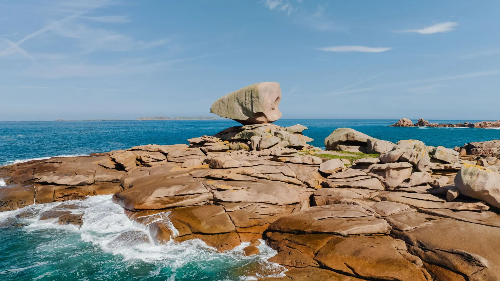 Cliffs and rocks eroded by the sea, with waves crashing against the rock faces